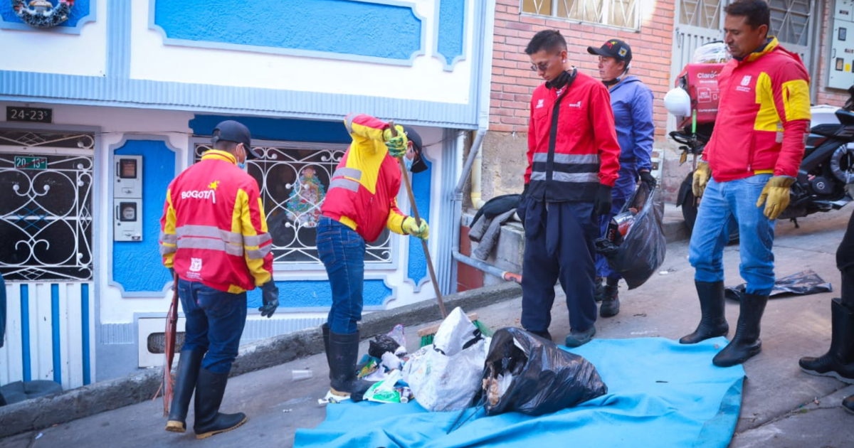Imagen de varios funcionarios recogiendo basura en la calle