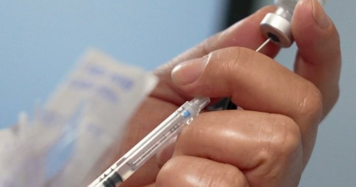 Foto que muestran unas manos sosteniendo una jeringa