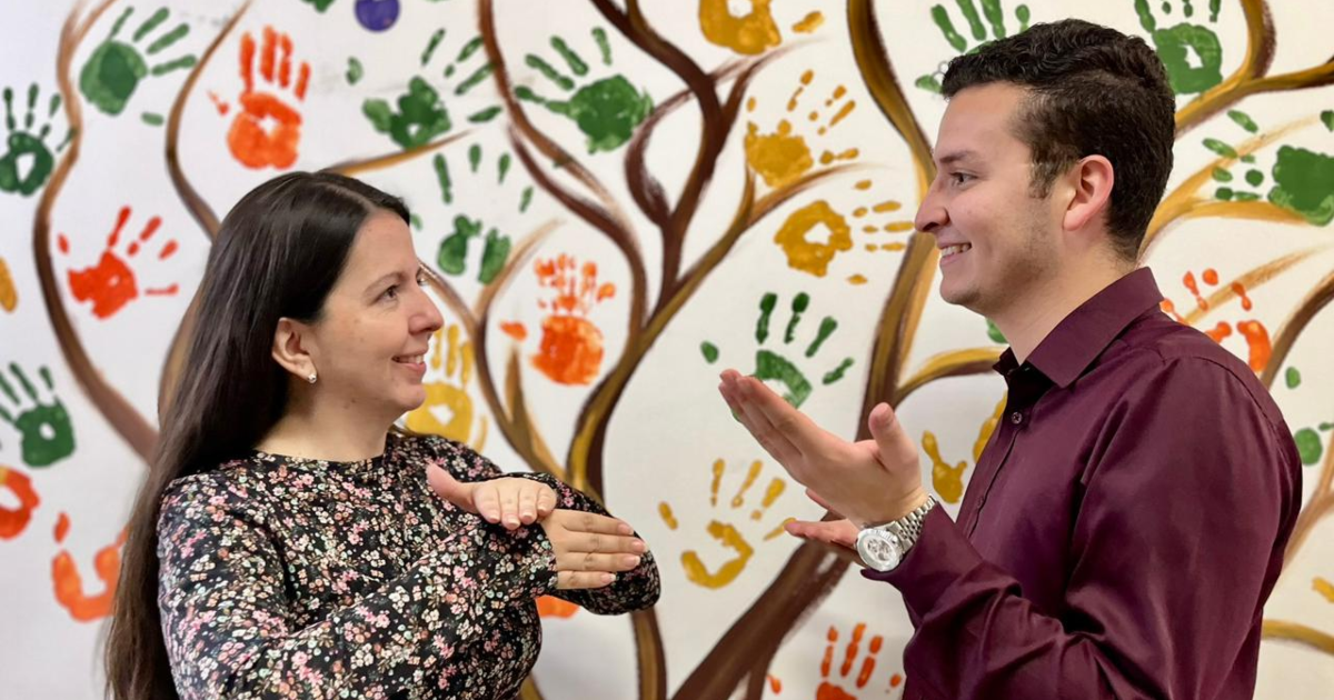 Dos personas comunicándose con Lenguaje de Señas