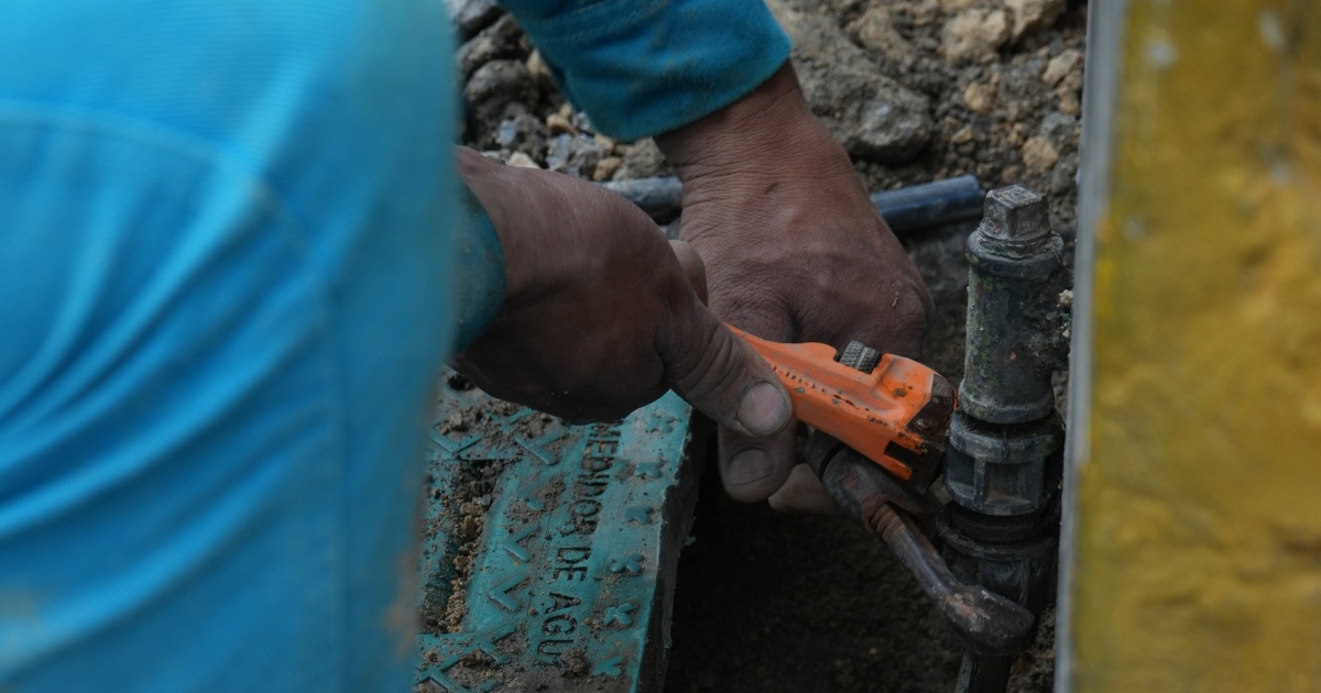 Foto que muestran unas manos reparando una tuberia