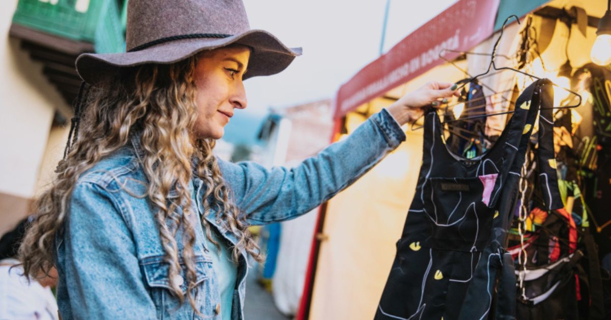 Imagen de mujer mirando un vestido en carpas de emprendimientos 