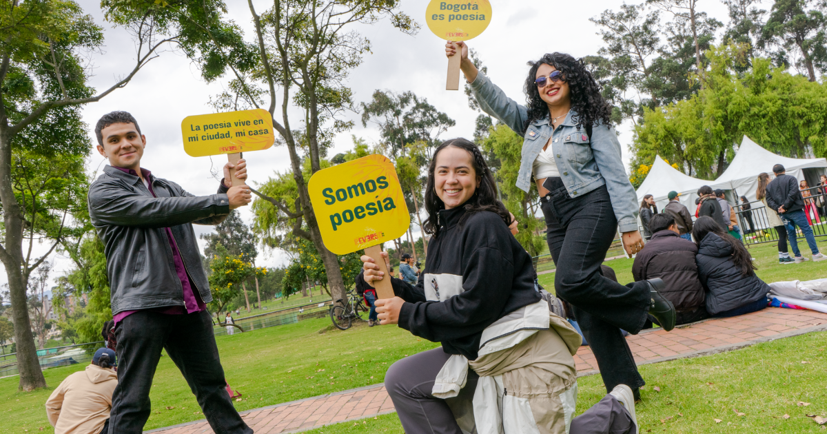 Imagen de un hombre y dos mujeres con carteles del Festival Reverso 2025