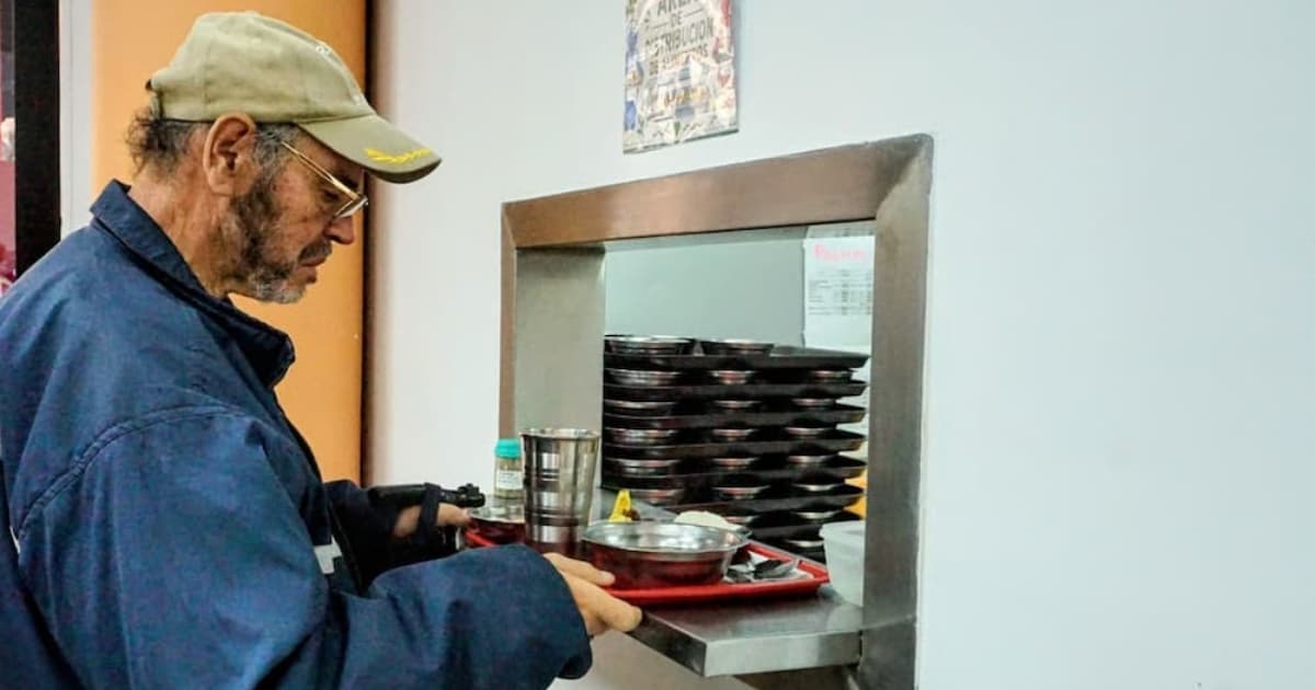 Un adulto mayor recibiendo alimentación en un comedor comunitario