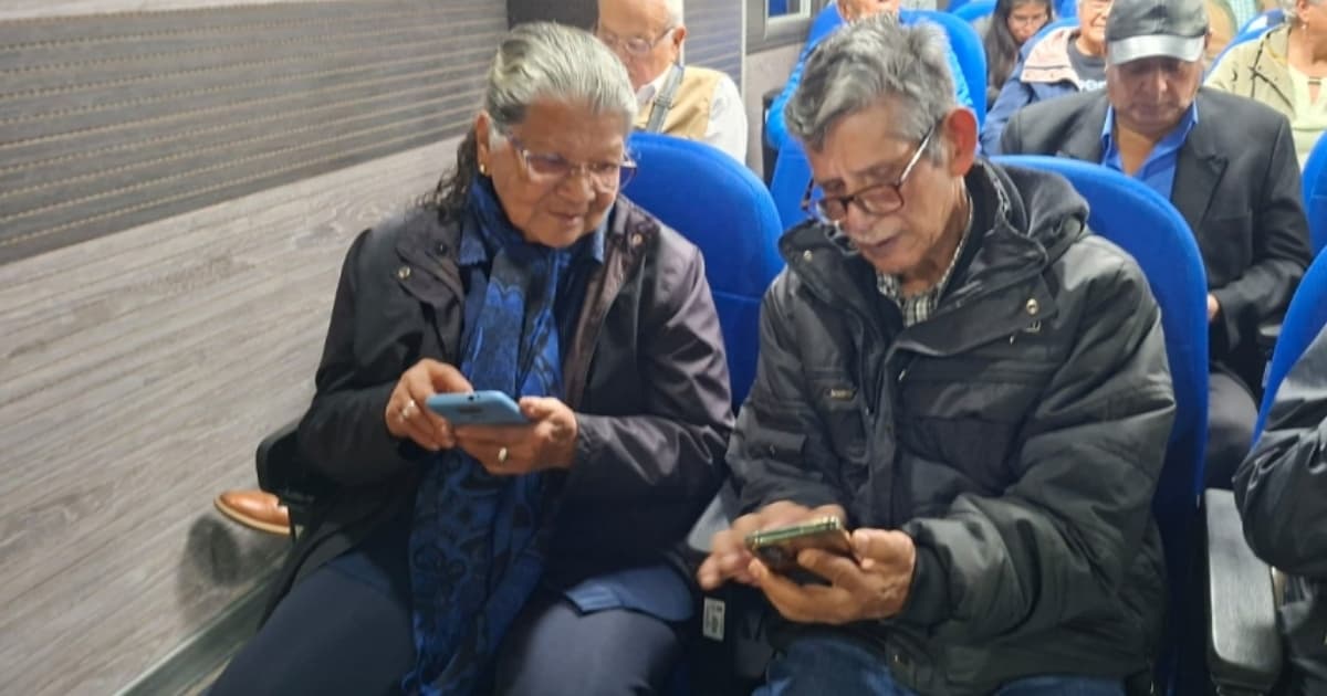 Dos adultos mayores revisando el celular 