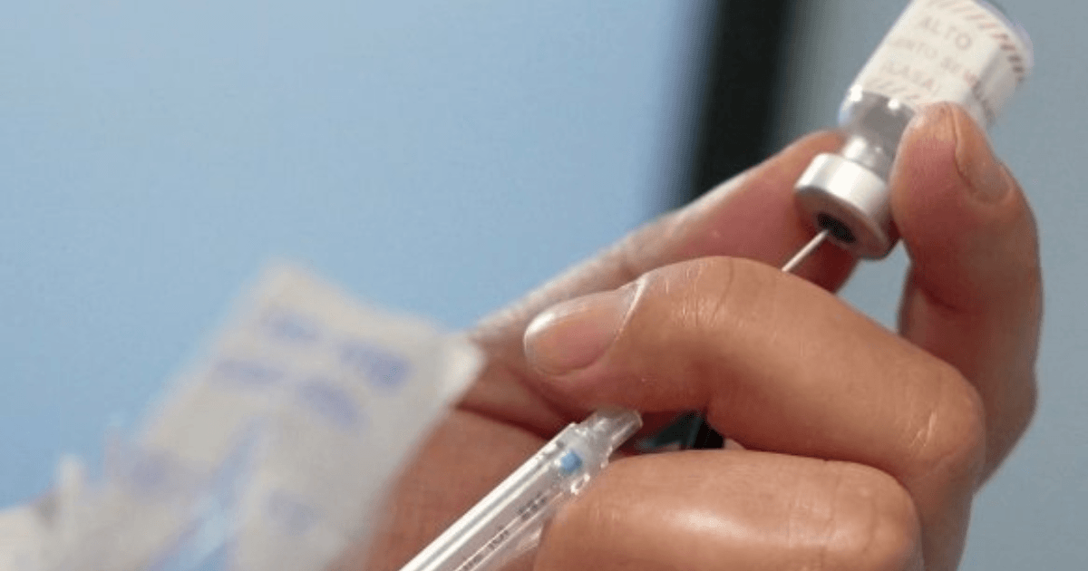 Foto que muestra unas manos sosteniendo una jeringa en una jornada de salud en Bogotá.
