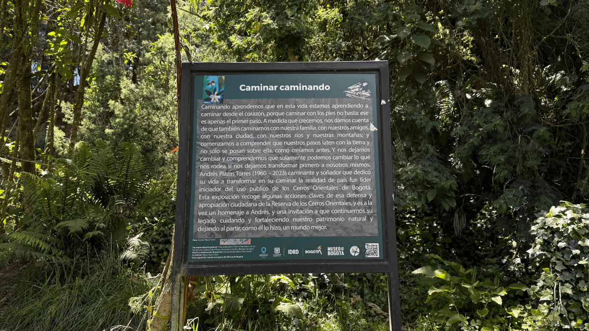 Panel informativo de la exposición “Caminar caminando” instalado entre la vegetación del sendero de Monserrate.