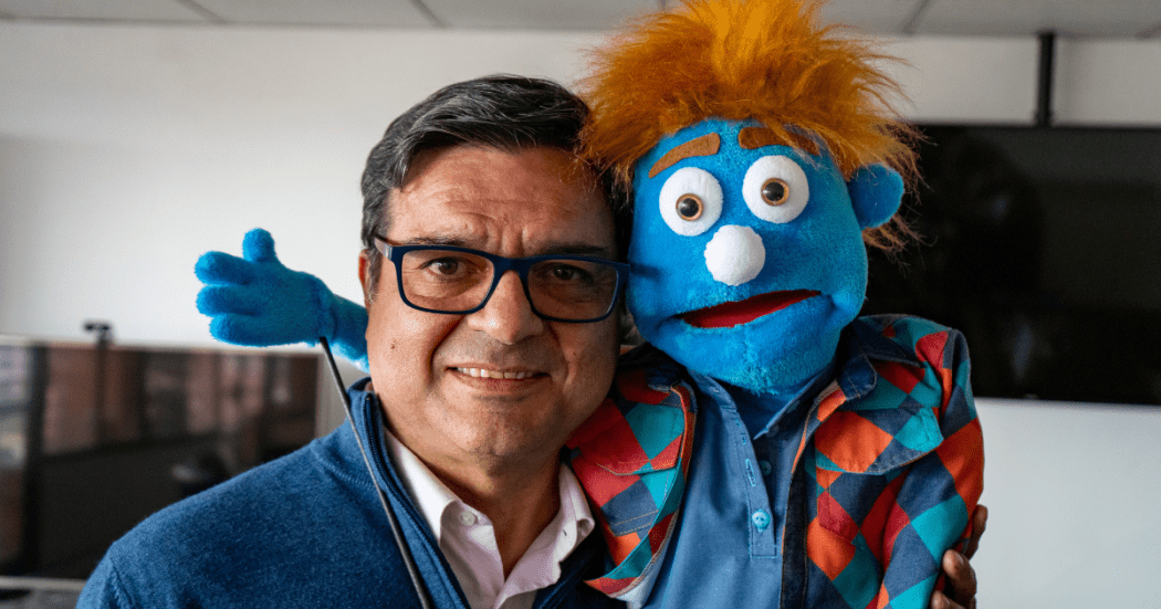 Fotografía del secretario de Salud con un titere azul 