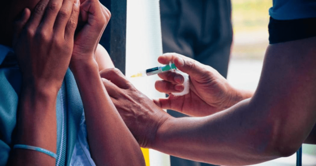 Imagen de una enfermera vacunando a una mujer en el brazo