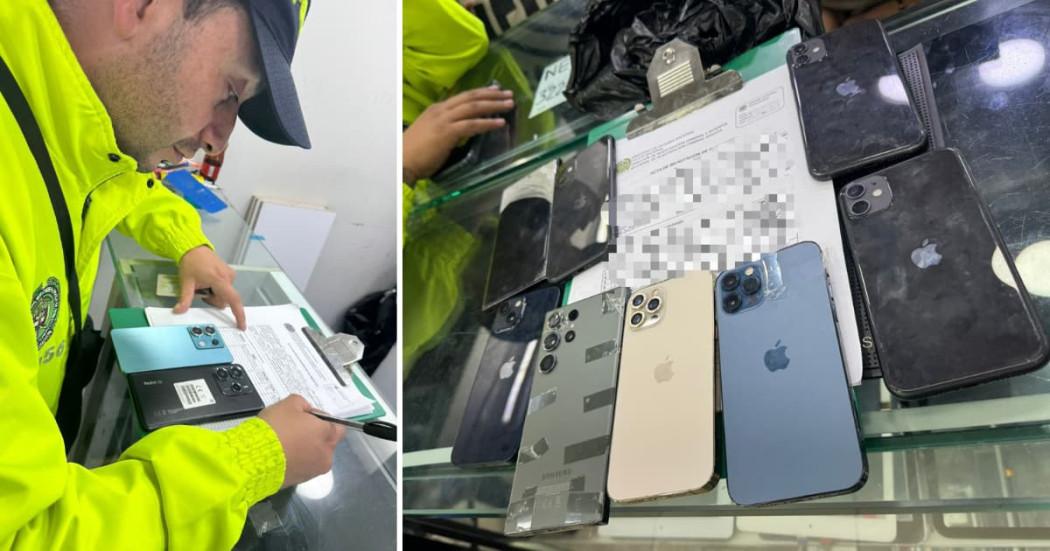 Uniformado de la Policía de Bogotá realizando inspecciones a celulares en establecimientos de comercio.