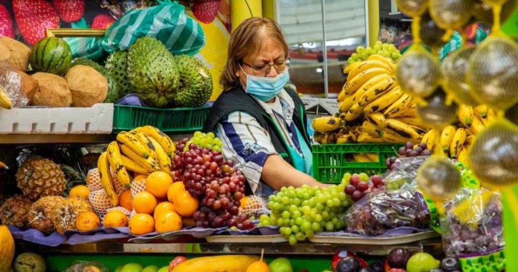 Una mujer comerciante de una de las Plazas Distritales de Mercado en su puesto de frutas.