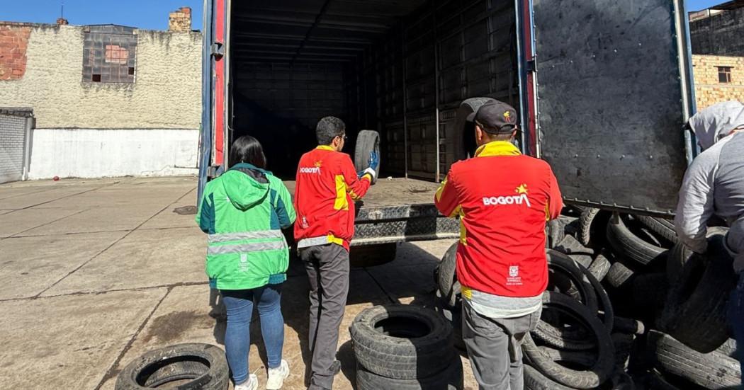 Foto que muestra personas recolectando llantas en desuso
