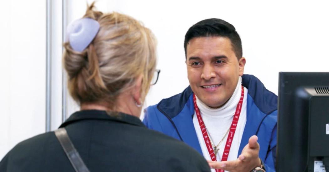 Foto de un funcionario del IPES entregando información sobre los cursos gratis de manipulación alimentos y formación para el trabajo.