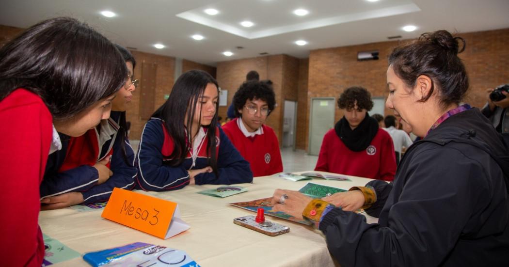 Foto que muestra estudiantes sentados en una mesa 