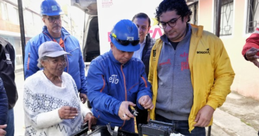 Imagen de un operario de ETB con el secretario de Integración Social y una ciudadana
