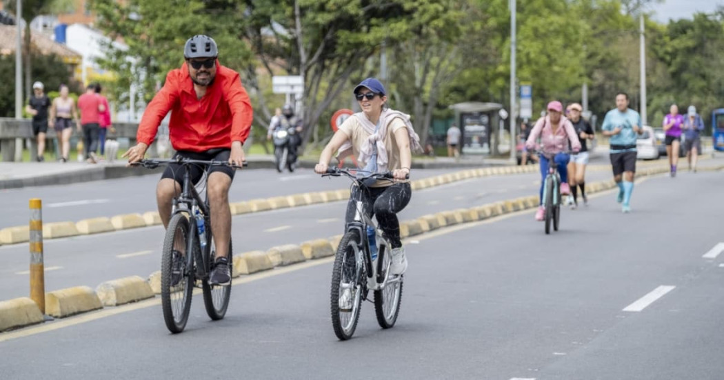Personas en bicicleta recorren ciclovía urbana acompañadas por corredores y peatones Bogotá