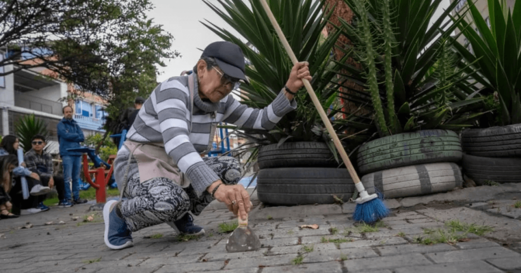 Foto que muestra una mujer arrodillada limpiando el piso 