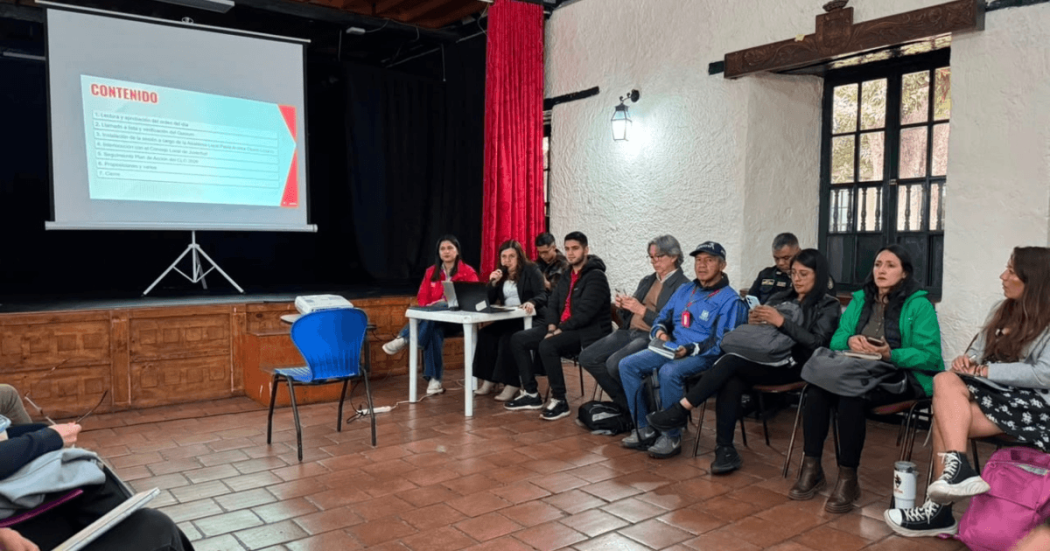 Foto que muestra personas reunidas en un salón hablando