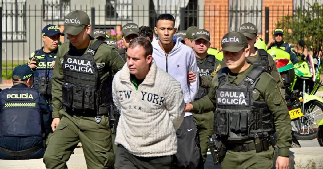 Foto de dos de los capturados junto a hombres de la Policía.