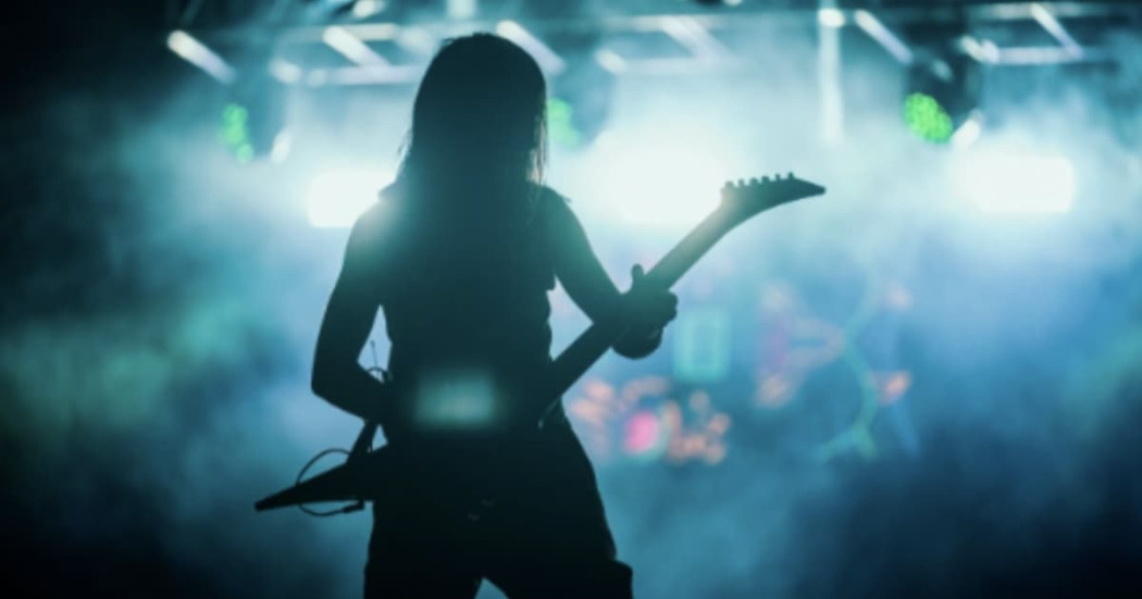 Foto de un hombre tocando guitarra eléctrica en tarima de Rock al Parque.