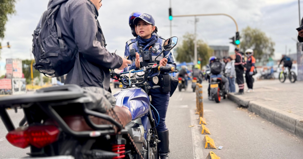 Foto de una agente de transito hablando con un ciudadano 