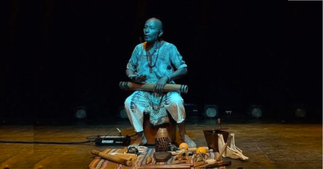 Imagen del artista afroperuano sentado tocando un timbal.