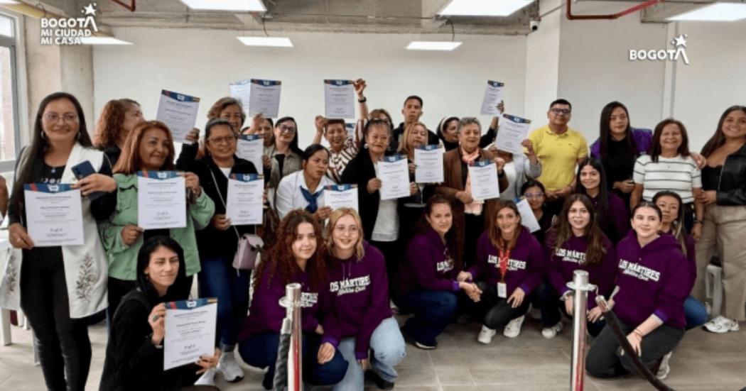 Foto que muestra mujeres sonriendo con diplomas en las manos 