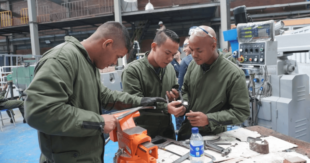 Foto que muestra tres hombres con el uniforme del SENA 