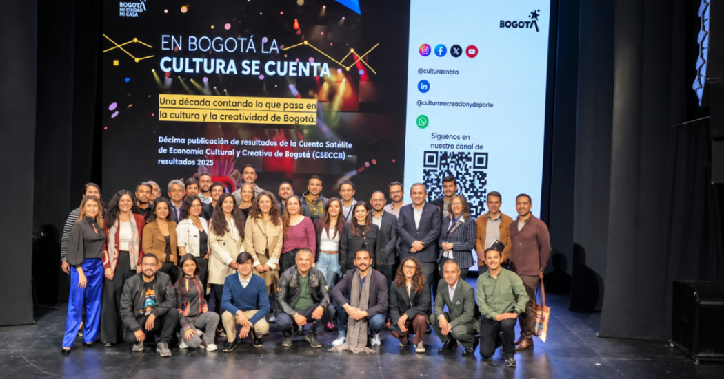 Imagen de varias personas en un escenario con caras de celebración.