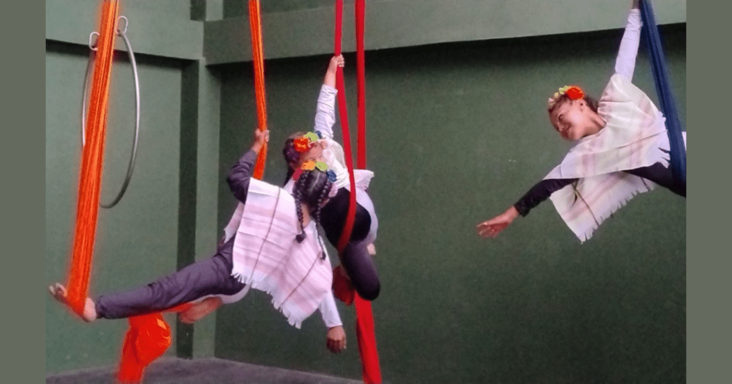 Imagen de dos marabaristas pendiendo de cuerdas de una mano y un pie