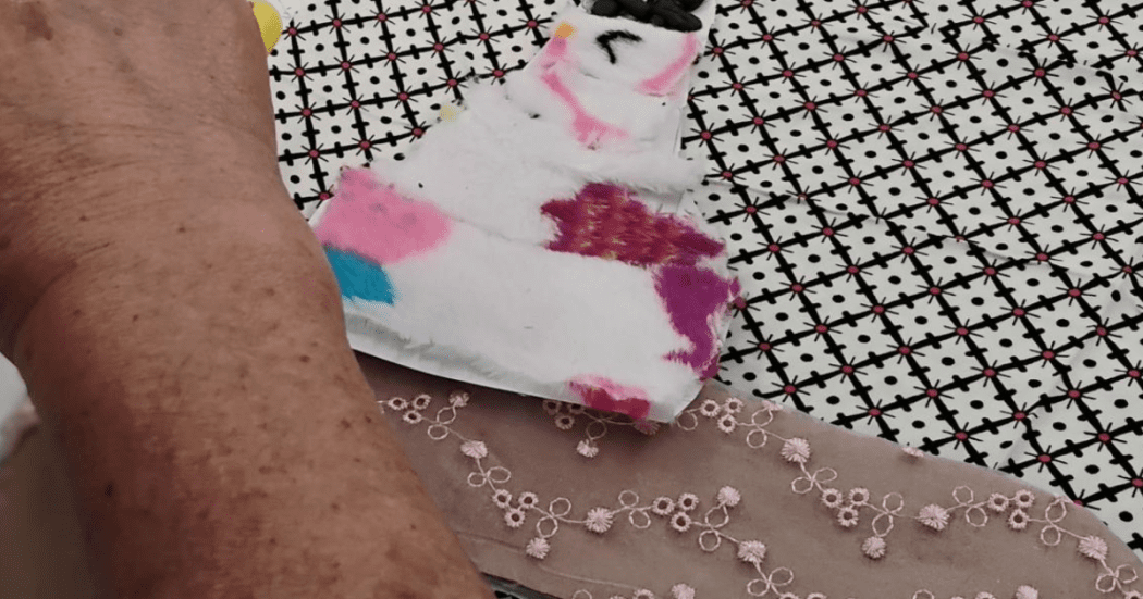 Foto de una persona mayor trabaja con telas y texturas