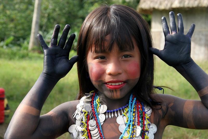 Retrato de una niña indígena mostrando sus manitos.