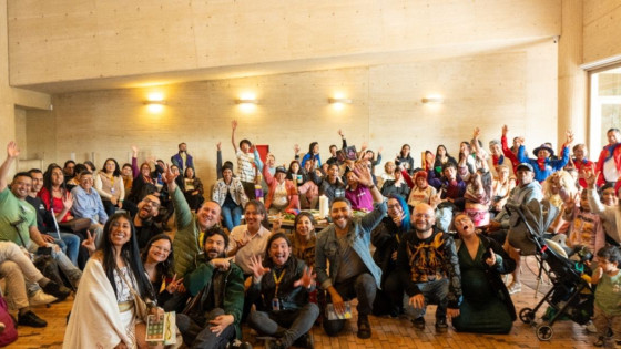 Imagen de grupo de personas con mano levantada de celebración en instalaciones de BibloRed