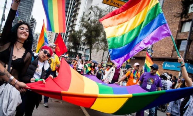 Foto integrantes de comunidades LGBTI con banderas en Bogotá durante una manifestación.