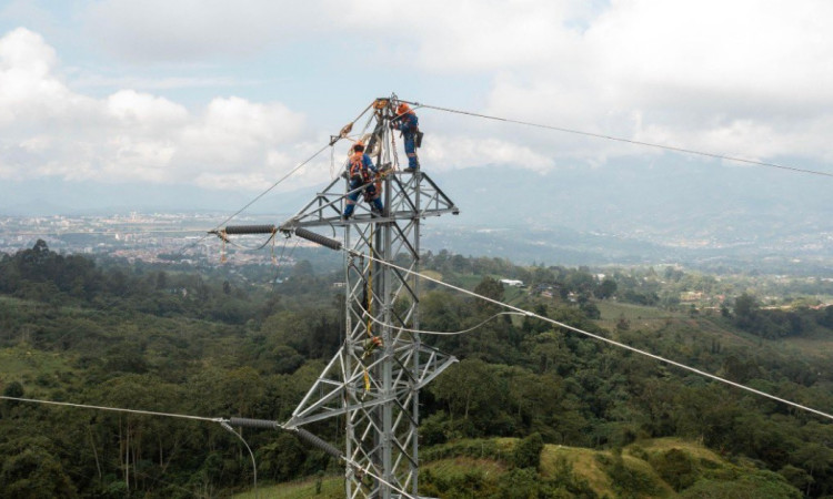 Foto que muestra dos personas con el uniforme de Enel Colombia trabajando en una antena de energía