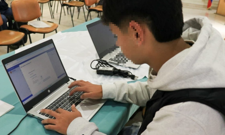 Foto que muestra a un hombre escribiendo en un computador 