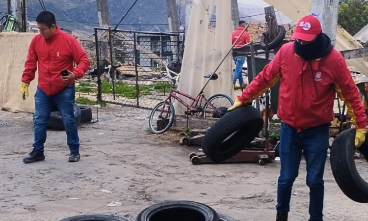 Imagen de dos funcionarios recogiendo llantas en la localidad de Usme