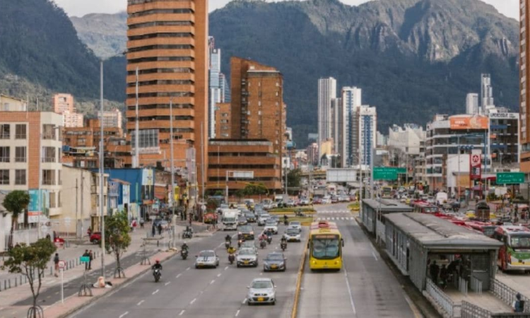 Foto de una vía de Bogotá donde se ven buses de TransMilenio y carros