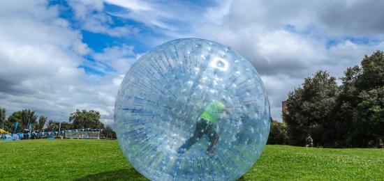 Un niño se desplaza en una esfera plástica gigante, que hace parte de las atracciones del Festival de Verano 2019.