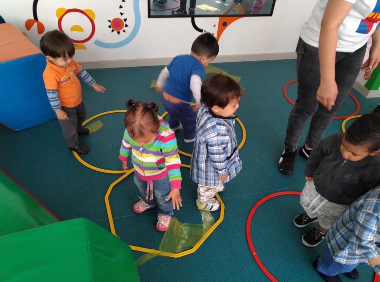 Las niñas y los niños del nivel de caminadores del Jardín Infantil El Nogal de la Esperanza, en la localidad de Barrios Unidos, realizan actividades físicas con diferentes elementos que fortalecen sus habilidades motoras. 