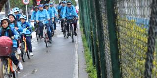 El secretario de movilidad junto a un grupo de niños montando bicicleta por una cicloruta 