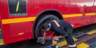 Imagen de una persona limpiando un bus de TransMilenio