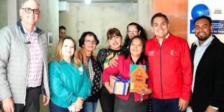 Foto que muestra al director de la Caja de Vivienda junto con las familias que recibieron su casa