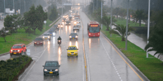 Imagen de varios vehículos transitando bajo la lluvia en la avenida El Dorado