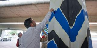 Foto del alcalde Carlos Fernando Galán embelleciendo con pintura el espacio público del bajo puente de la avenida Boyacá con calle 26.
