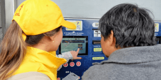 Imagen de una operaria ayudando a un usuario de TransMilenio