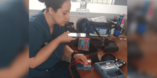 Imagen de funcionaria calibrando equipo