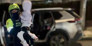 Foto de un policía junto a la niña rescatada en Bogotá.