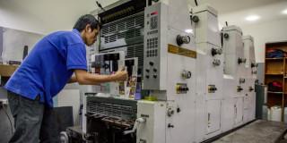 Foto de un comerciante en su negocio de impresión digital en Bogotá.