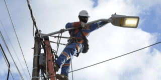 Imagen de un técnico de ENEL realizando mantenimiento en un poste de luz.