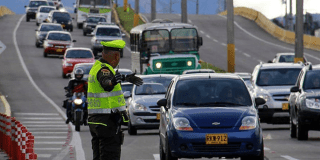 Imagen de varios vehículos transitando en una avenida de Bogotá